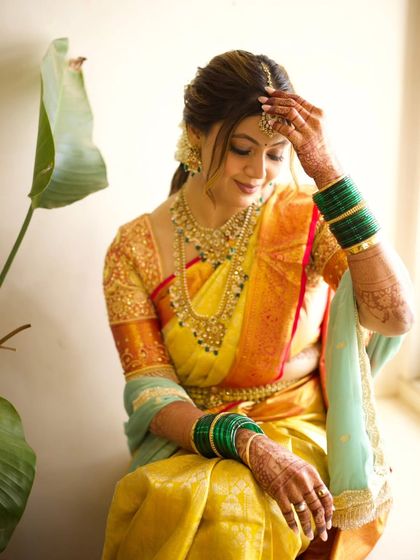 A quiet moment with a beautiful bride before her ceremony. Her yellow and orange saree is perfectly complemented by the simple, elegant hairstyle I created for her.