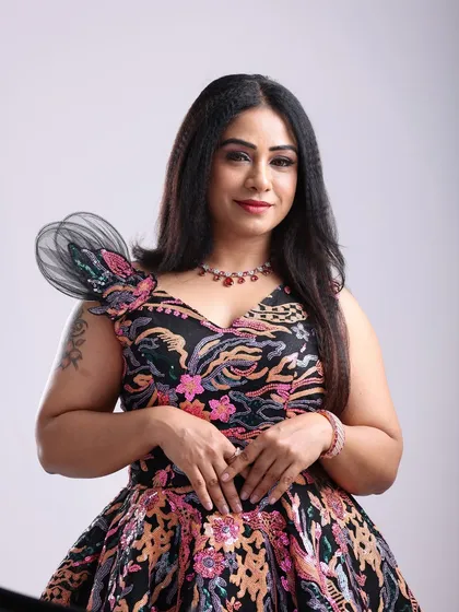 A beautiful portrait in a modern, floral-patterned gown with a unique structured shoulder detail. This dress is perfect for a contemporary fashion shoot.