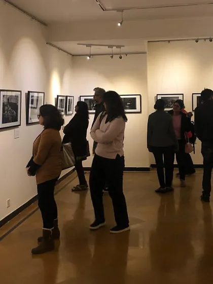 Visitors engaging with the poignant photography at our Gurgaon centre gallery. We create an immersive environment where guests can connect deeply with the stories behind the art.