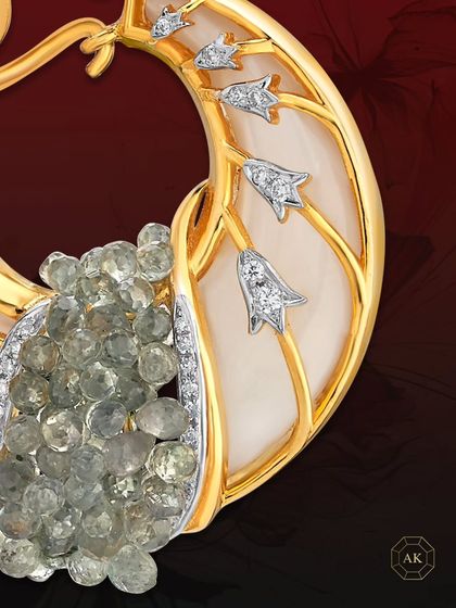 A one-of-a-kind earring from our collector's edition. It features Mother of Pearl adorned with intricate gold detailing, green onyx briolettes, and diamonds, inspired by organic beauty.