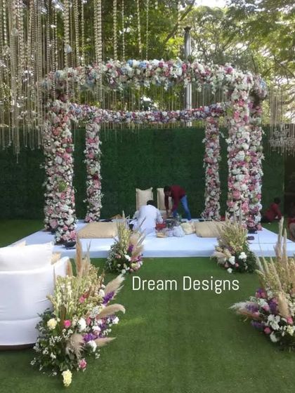 A circular mandap design offers a unique and intimate setting for the ceremony. This one is framed with lush florals and features comfortable lounge seating for a modern approach to wedding rituals.
