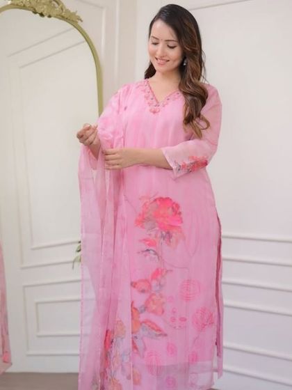 A pretty light pink organza kurta with a delicate floral print. The fabric is so light and airy, making it perfect for a summer event.