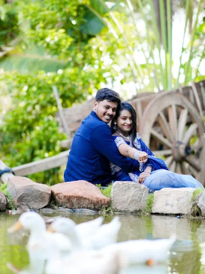 A charming pre-wedding photo by a pond with ducks. This natural, rustic setting is perfect for a peaceful and romantic shoot.