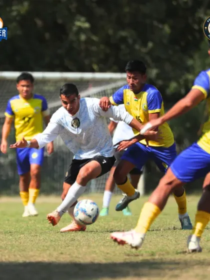 Surrounded by defenders, our player skillfully maneuvers to keep possession and find a teammate.