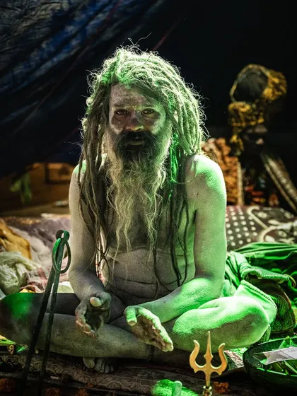 The atmosphere inside the sadhus' tents was otherworldly. I used the available light to capture the moody, intense feeling of the space. This man, covered in sacred ash with his trishul, sat with a quiet power that was palpable.