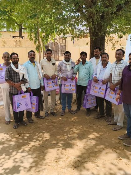 A group of satisfied farmers from Med village, Jaipur, holding Automat information kits after a successful Kisan Sabha. We ensure every participant leaves with useful resources and a direct point of contact for future support.