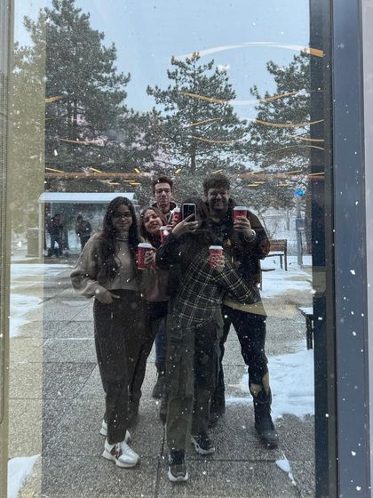 A fun, candid group selfie with friends on campus, capturing the social aspect of college life.