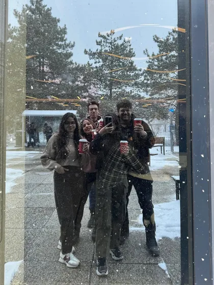 A fun, candid group selfie with friends on campus, capturing the social aspect of college life.