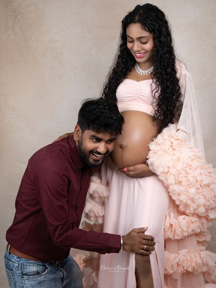 A playful and loving moment as the dad-to-be listens to the baby bump. This is always a fun and heartwarming shot to capture.