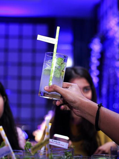 A guest being served a freshly made Mojito. I ensure every drink is handed over with a smile, making the service as pleasant as the cocktail itself.