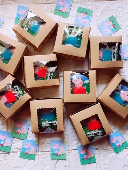 Peppa Pig themed return favors, with personalized name soaps packaged in window boxes.