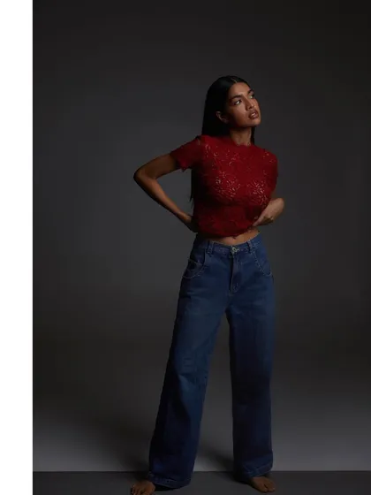 A full-length shot combining a delicate lace top with casual jeans. This demonstrates how I can style and shoot for a more relaxed, contemporary fashion look.