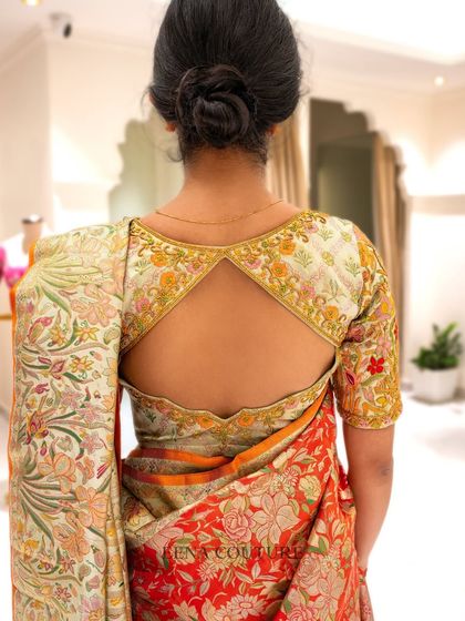 My client Harshitha radiates pure elegance in this stunning ensemble. I paired a vibrant, floral Banarasi silk saree with a custom blouse featuring multi-colored thread embroidery that perfectly picks up the hues in the saree.