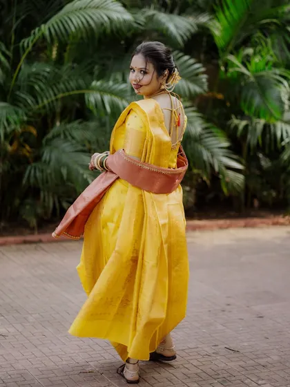 A graceful shot of the bride showing off the beautiful drape of her Nauvari saree.
