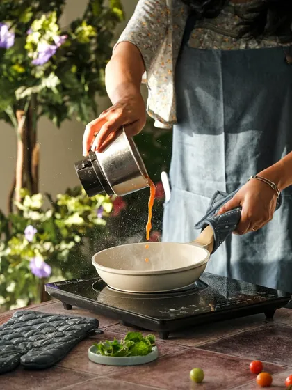 A shot of me in action, cooking for a food photography shoot. This shows that we get hands-on, combining cooking and videography to get the perfect shot.