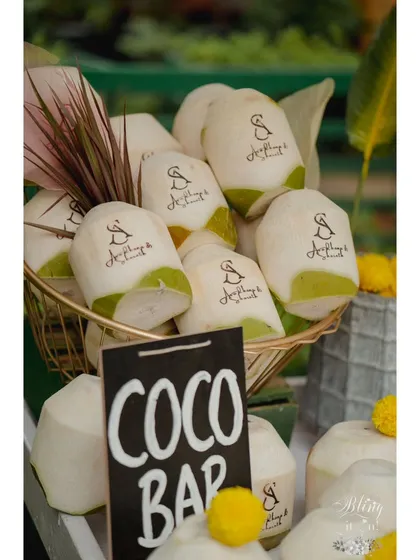A basket full of personalized coconuts ready for guests at the "Coco Bar." This thoughtful detail ensures that guests feel welcomed and cared for from the moment they arrive.
