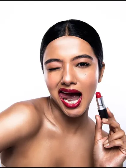 A fun, flirty beauty portrait. This kind of expressive shot is great for social media campaigns, creating an instant connection with the viewer.