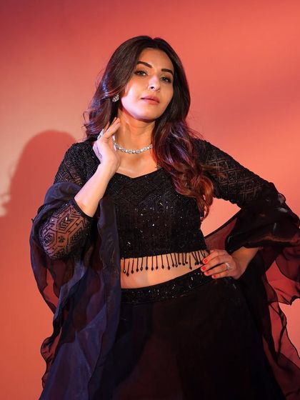 A close-up of the black lehenga's blouse, highlighting the intricate geometric sequin pattern and the flattering neckline.
