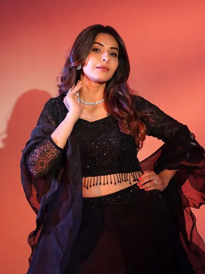 A close-up of the black lehenga's blouse, highlighting the intricate geometric sequin pattern and the flattering neckline.