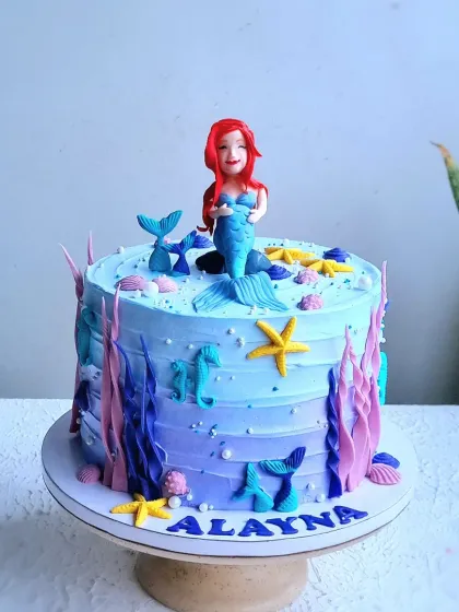 A full view of the mermaid cake, showing the ombre buttercream and underwater decorations.