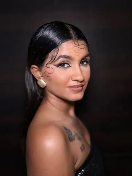 A modern editorial look featuring a sharp graphic eyeliner and a wet-hair style. This demonstrates my skill in creating clean, high-fashion makeup that stands out in photos, ideal for portfolio building or brand campaigns.