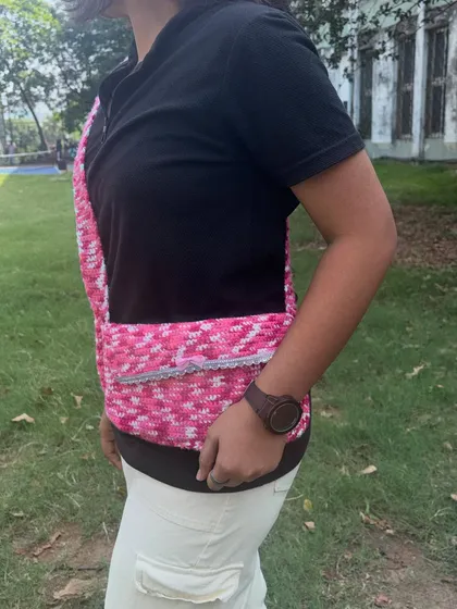 Side view of the crochet messenger bag. The strap is thick and sturdy so it's comfortable to wear all day.