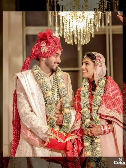 A classic portrait of the couple during their Marwari wedding ceremony, capturing the details of their traditional attire and the loving look they share.