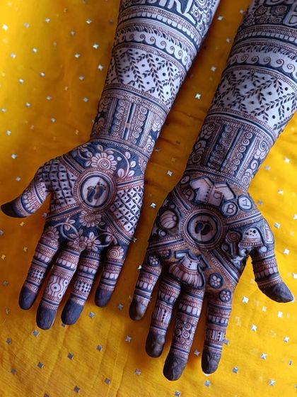 This image shows the complete design, with personalized text on the forearms and intricate, symbolic motifs on both palms, celebrating the new life to come.