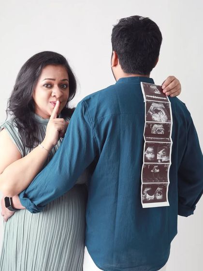 "Shhh, we have some news!" This fun and creative shot uses the ultrasound as a reveal, capturing the couple's excitement and playful spirit.