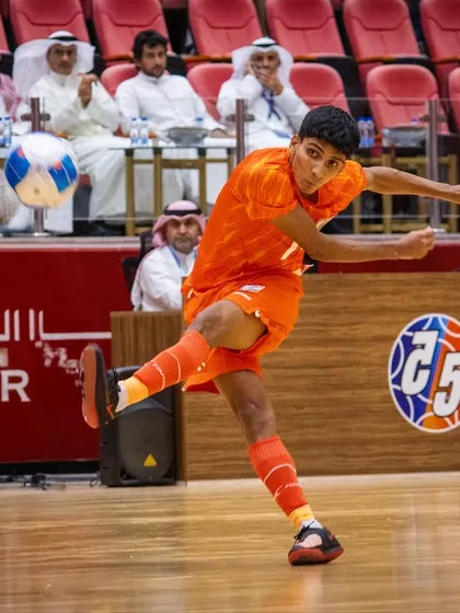 An action shot from the match against Kuwait, with our player executing a powerful volley.