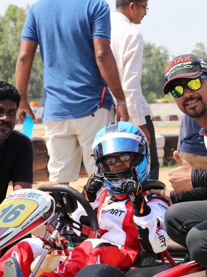 A young driver gets encouragement from our team members before heading out for a race, showing our supportive environment.