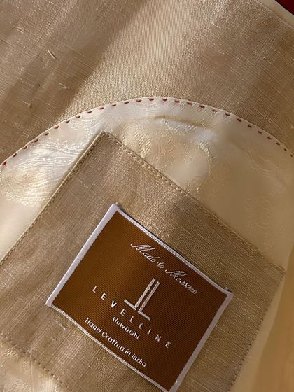 The inside of a bespoke blazer tells a story of craftsmanship. Here you can see our hand-crafted label, the luxurious lining, and the fine internal stitching.