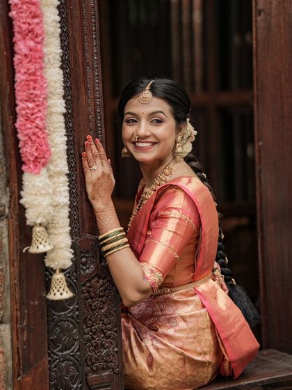 A happy, smiling bride. The makeup is designed to look bright and radiant, enhancing her joyful expression on her special day.