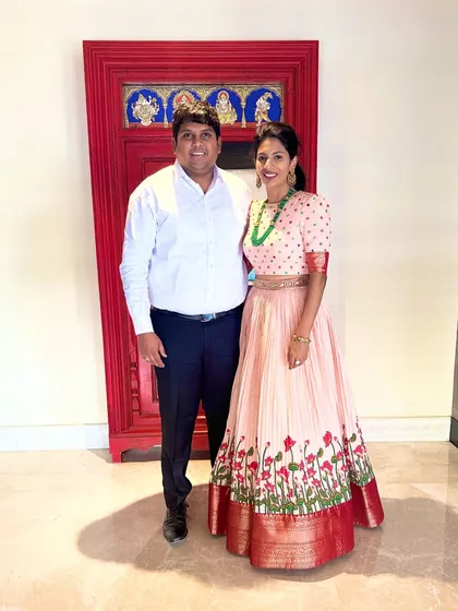 The couple stands proudly, our client's peach anarkali a beautiful centerpiece.