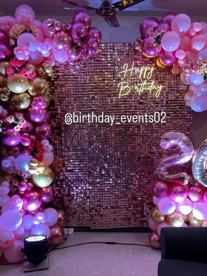Make your celebration shine with our rose gold sequin wall. This setup is perfect for creating a glamorous atmosphere, complemented by a lush balloon arch in shades of pink and gold, a neon sign, and foil age balloons.