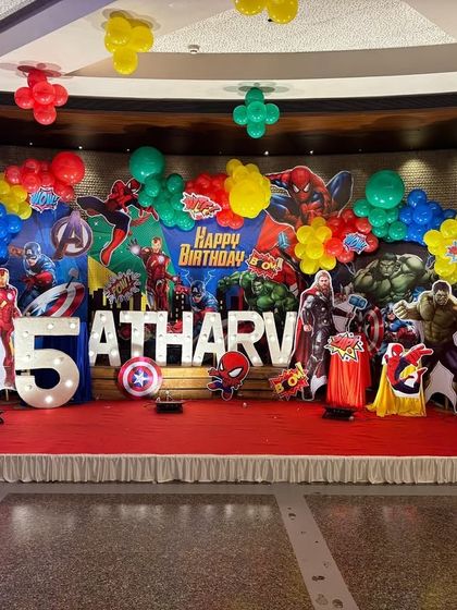 A full, front-on view of the impressive Marvel birthday stage, showing the scale and detail of the entire setup.