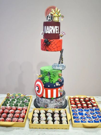A gravity-defying Marvel-themed cake that stands over five feet tall. Each tier represents a different Avenger, from Captain America's shield to Thor's hammer, all part of an epic dessert display for a true fan.