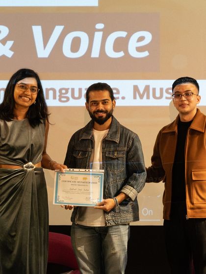 A participant proudly receiving his certificate at the 'Verse & Voice' showcase. This official recognition from Delhi Poetry Slam and the Goethe-Institut is a valuable addition to any writer's portfolio.