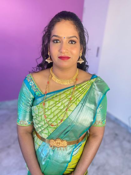 The finished look. The makeup is classic and elegant, and the half-up, half-down curly hairstyle adds a touch of modern romance.