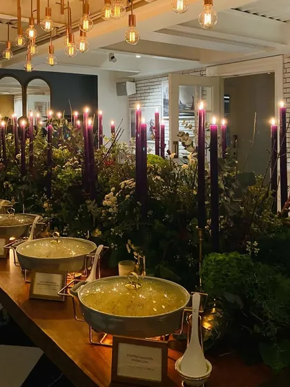 Another view of the purple-themed buffet, showing our stylish serveware and the warm lighting from the Edison bulbs above.