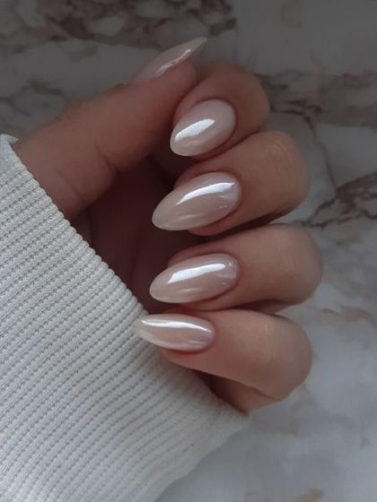 The glazed donut trend is here to stay. A simple, pearly white chrome on almond-shaped nails for that clean and polished look.