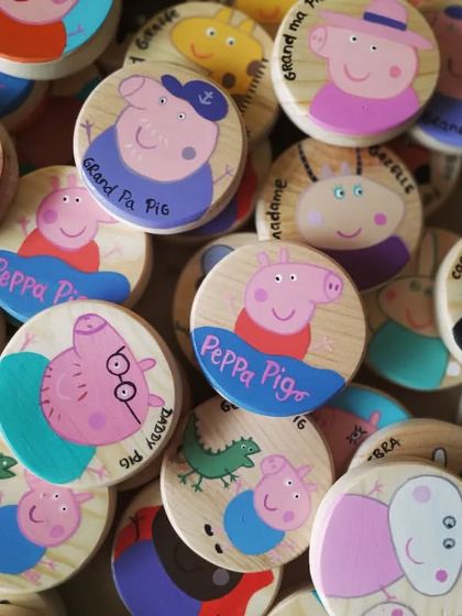 A playful pile of our Peppa Pig wooden game pieces. Creating these 48 custom tiles flooded our studio with color and fun.