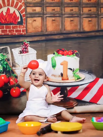 A wide shot of the baby chef theme, showing the personalized chalkboard and colorful toy ingredients.