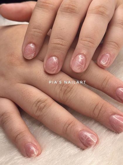 This is an acrylic overlay on natural nails, topped with a cat eye effect. An overlay adds strength to your own nails, helping them grow long and strong without breaking.