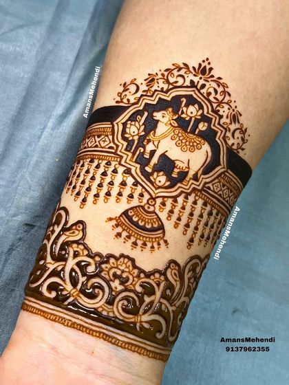 A beautiful arm band featuring a sacred cow (Kamdhenu) in a decorative frame. The hanging bell and intricate border add to the divine feel of the design.