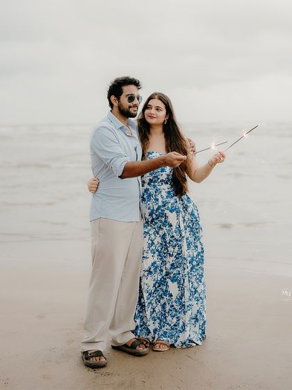 Lighting up their love story with sparklers on the beach. This adds a touch of celebration and magic to their seaside pre-wedding portraits.