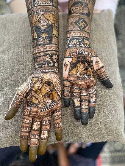 A truly personalized bridal mehendi featuring a couple's portrait. The design also includes a dancing bride figure, a swastika symbol for good fortune, and other traditional wedding motifs.