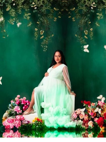 A dreamy shot in our mint green gown, surrounded by flowers and butterflies for an ethereal and whimsical feel.