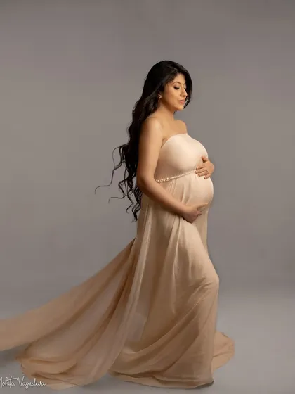 A beautiful profile in a soft, neutral-toned gown. The flowing fabric adds a touch of elegance and movement.