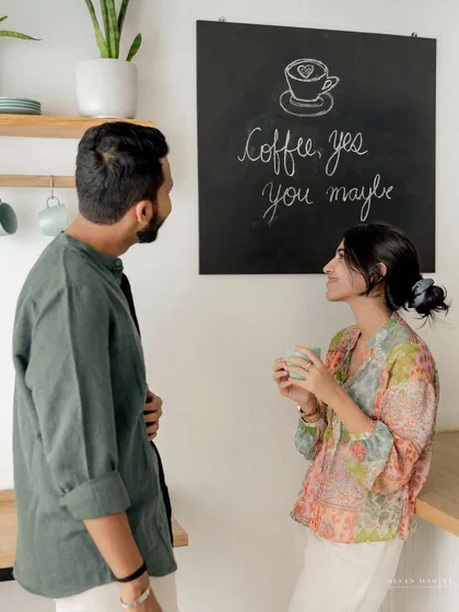 "Coffee, yes. You, maybe." A playful moment in a bright, modern kitchen setting. This lifestyle pre-wedding shoot is perfect for telling the story of your daily life together.